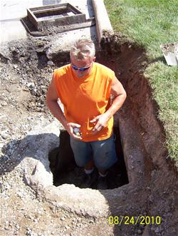 Man working on sewer system.